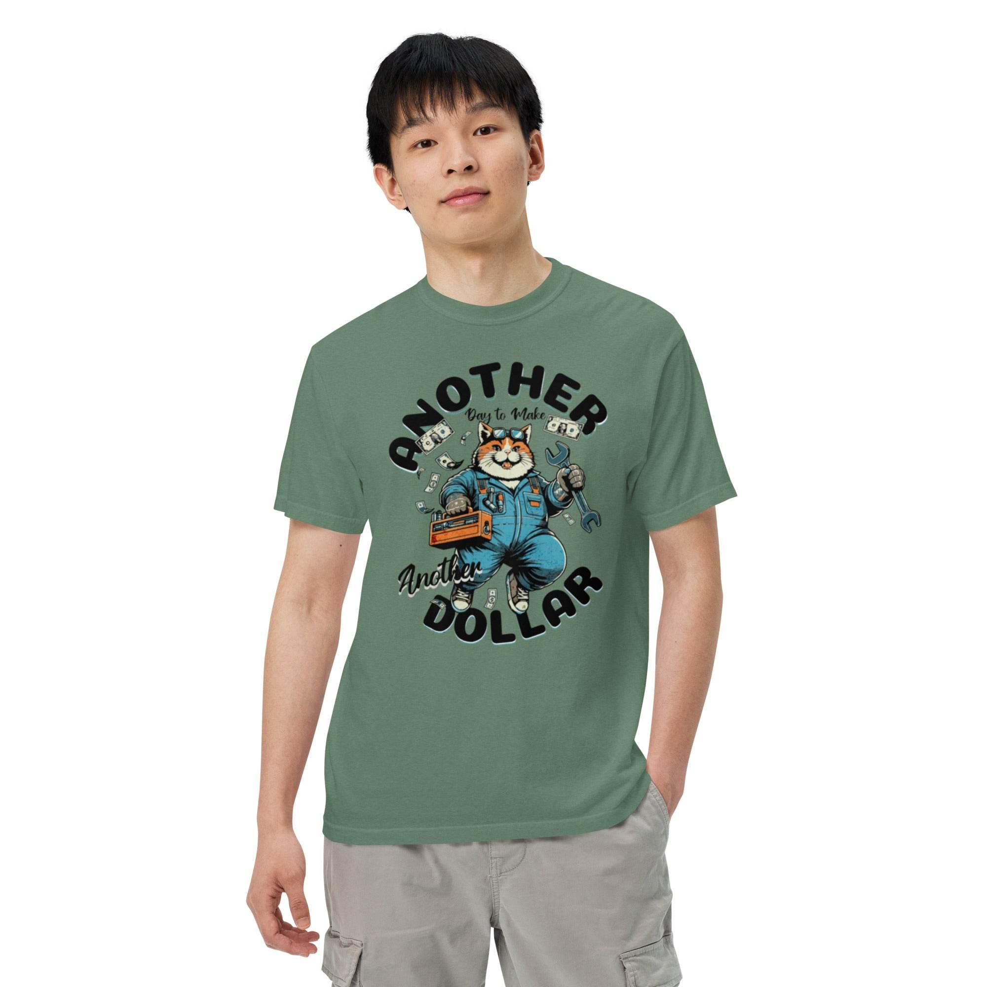 Light-green garment-dyed heavyweight t-shirt with retro cartoon workwear design – vintage-inspired bold graphic, titled Another Dollar. - Annaise Store
